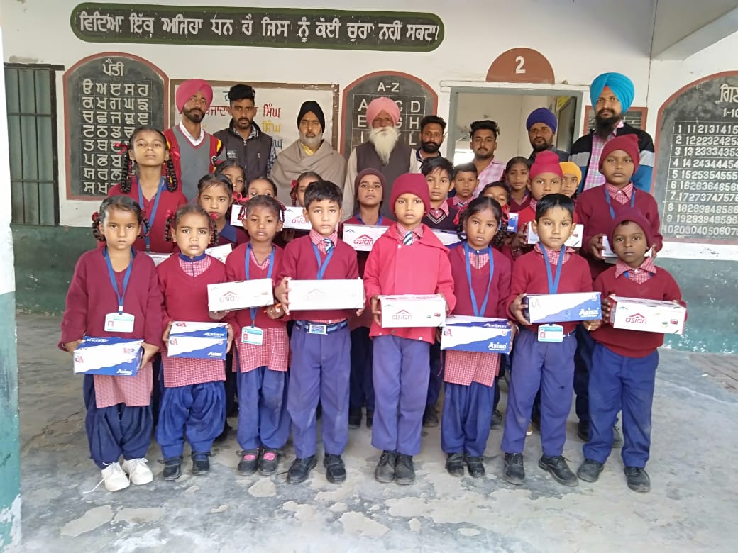 NRI team distributes uniforms and boots to needy students at Government Primary School Luhams